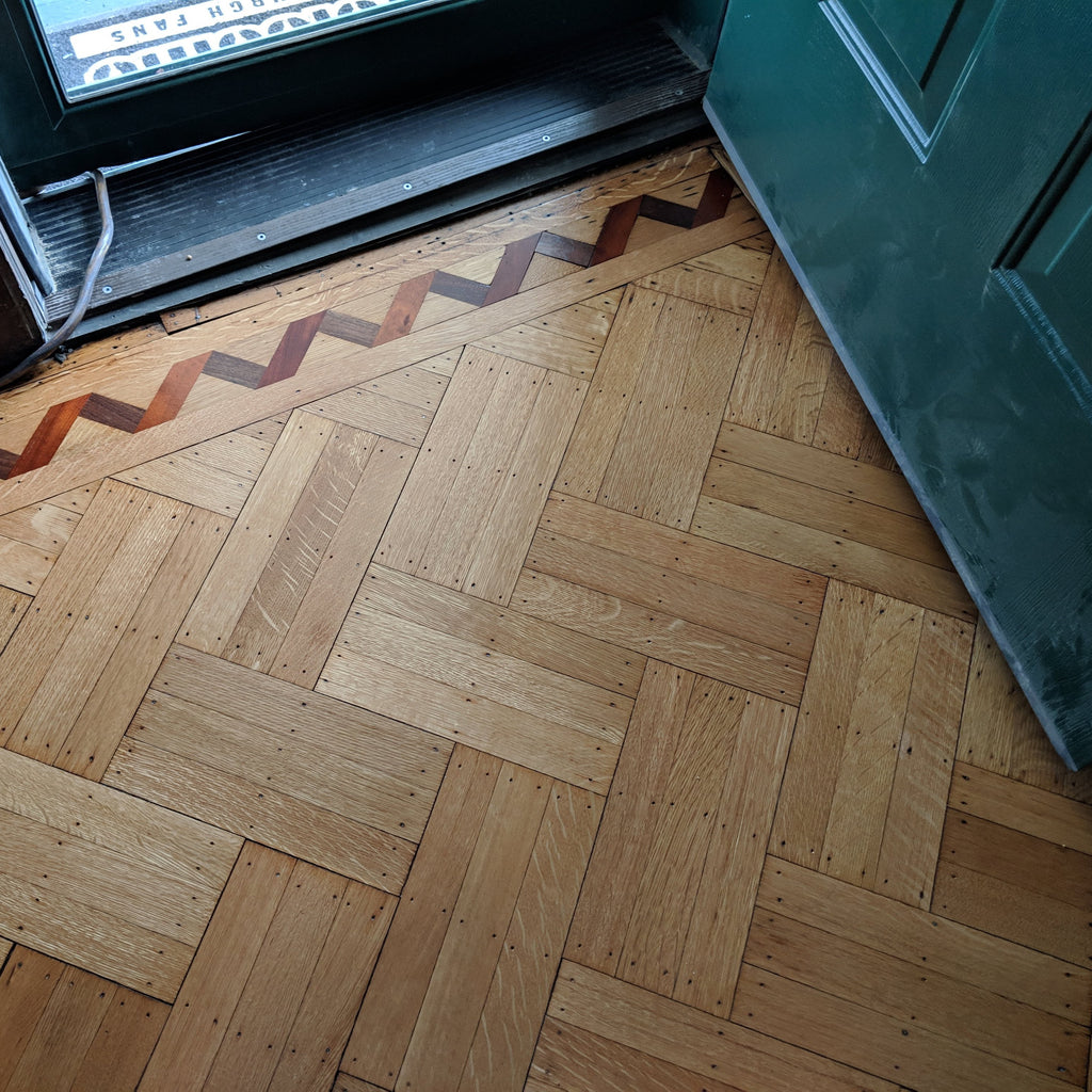 Parquet Refinish Creates a Stunning Focal Point to Entryway